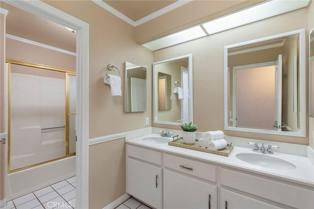 full bathroom with ornamental molding, double vanity, a sink, and tile patterned floors