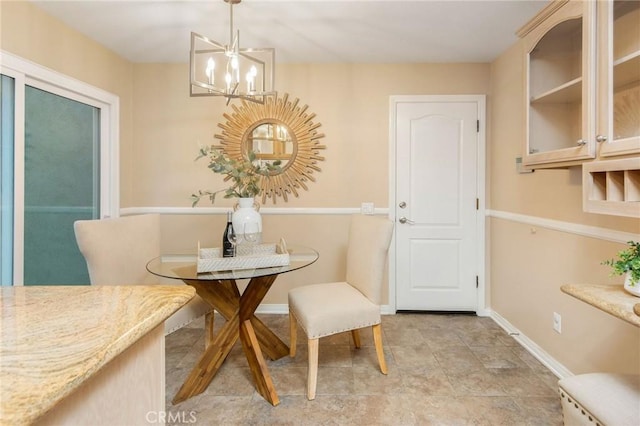 dining space with baseboards and an inviting chandelier