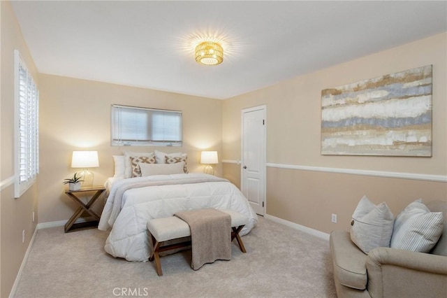 bedroom featuring light carpet, baseboards, and multiple windows