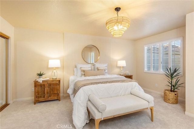 bedroom with baseboards, a chandelier, and carpet flooring