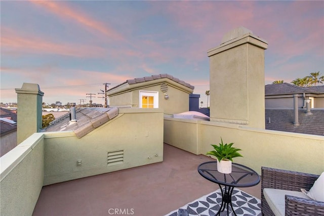 patio terrace at dusk with a balcony