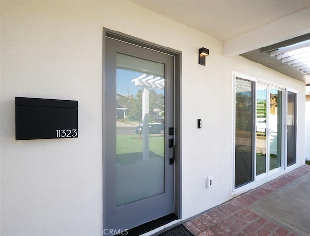 entrance to property with stucco siding