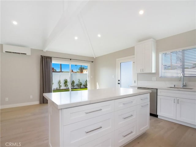 kitchen featuring dishwasher, a wall unit AC, vaulted ceiling with beams, a sink, and a wealth of natural light