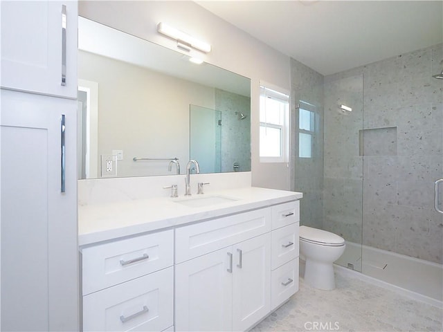 full bath with toilet, a stall shower, and vanity