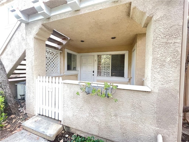 property entrance with stucco siding