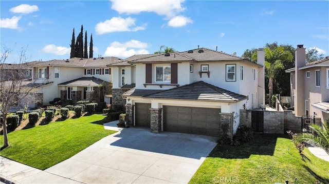 view of front of home featuring a garage, stone siding, driveway, a tiled roof, and a front lawn