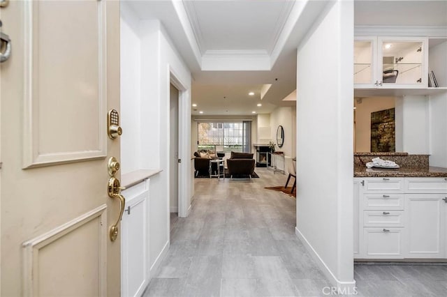 corridor featuring recessed lighting, baseboards, light wood-style floors, and ornamental molding