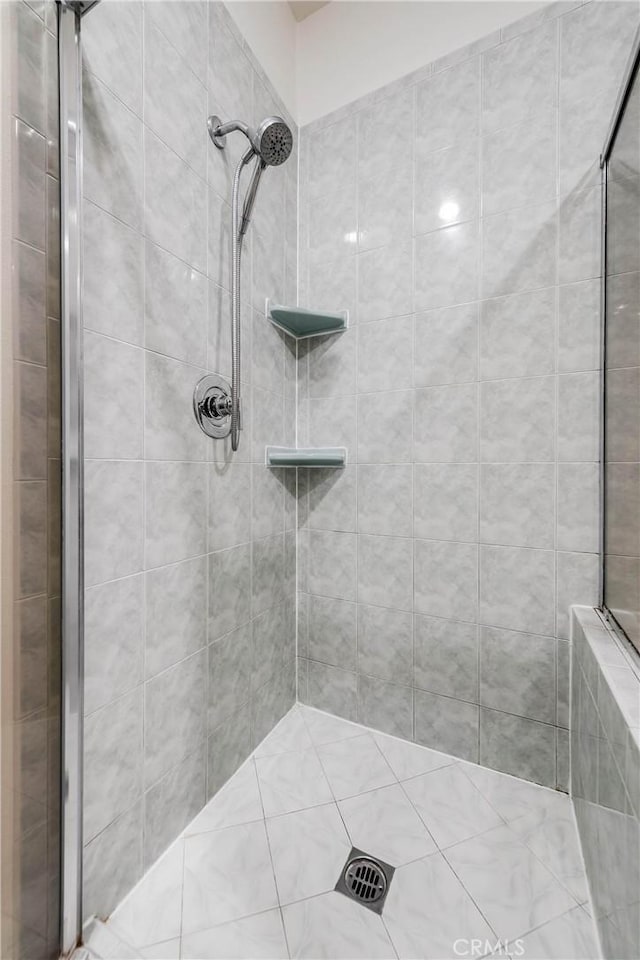 bathroom with tiled shower