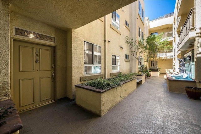 entrance to property with stucco siding