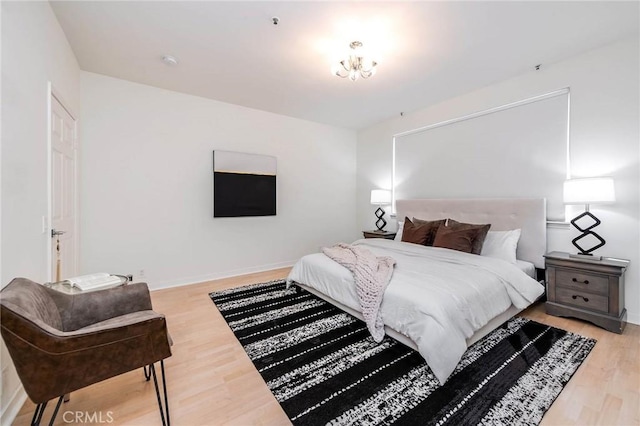 bedroom featuring baseboards and wood finished floors