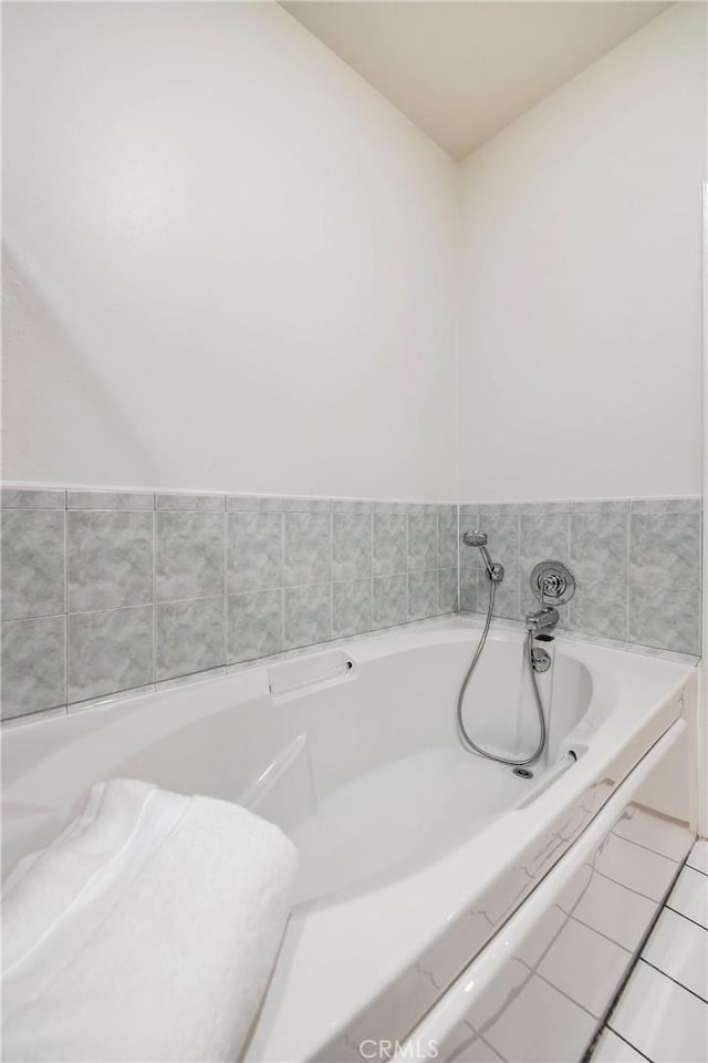 full bathroom with a bath and tile patterned flooring