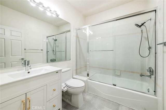 full bath with combined bath / shower with glass door, toilet, and vanity