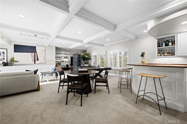 dining space with beam ceiling, coffered ceiling, light carpet, and a dry bar