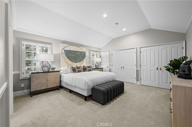 bedroom with multiple closets, recessed lighting, crown molding, lofted ceiling, and light colored carpet