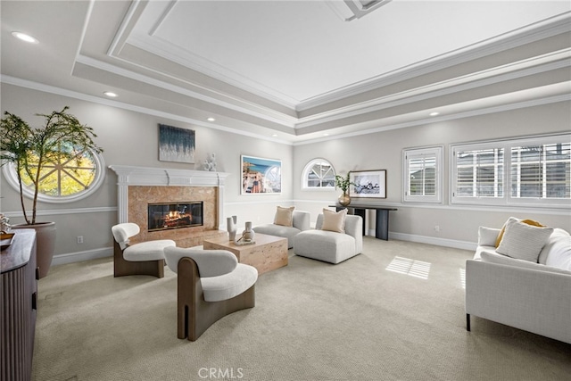 living room featuring carpet floors, a tray ceiling, and a premium fireplace