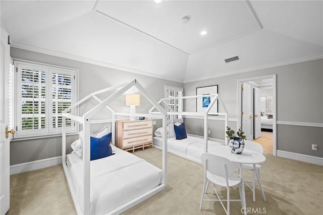 bedroom with visible vents, baseboards, lofted ceiling, ornamental molding, and carpet floors