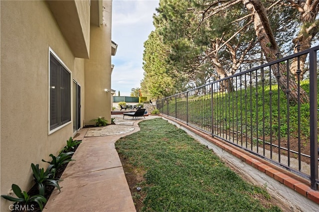 view of yard with fence and a patio area