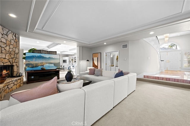 living room featuring carpet, visible vents, recessed lighting, a fireplace, and ornamental molding