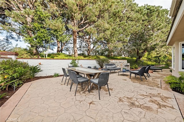 view of patio with outdoor dining area and fence