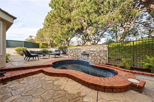 view of pool with a patio area and fence