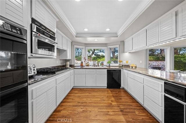 4 Huntington Ct, Newport Beach, CA 92660 - kitchen with black appliances, crown molding, recessed lighting, healthy amount of natural light, and white cabinets