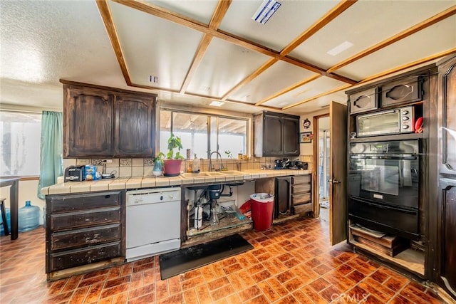 kitchen featuring oven, white dishwasher, tile countertops, and dark brown cabinets