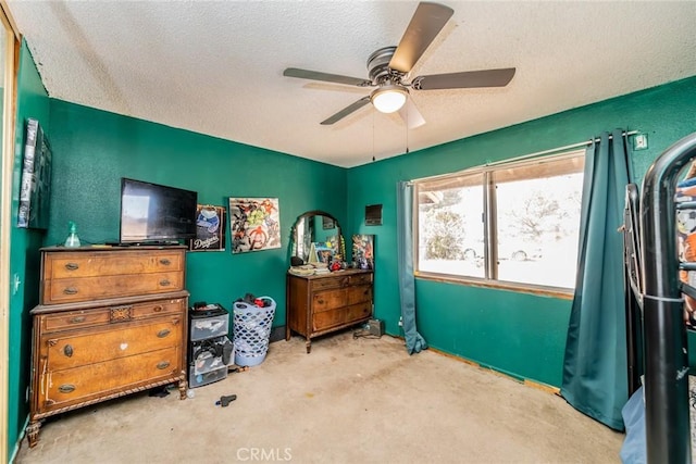 bedroom featuring ceiling fan and a textured ceiling