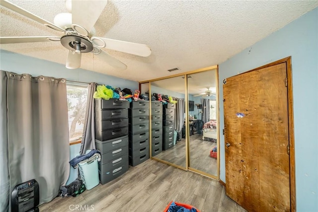 storage room featuring ceiling fan and visible vents