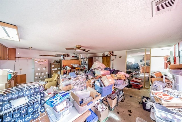 misc room featuring ceiling fan, visible vents, and a textured ceiling