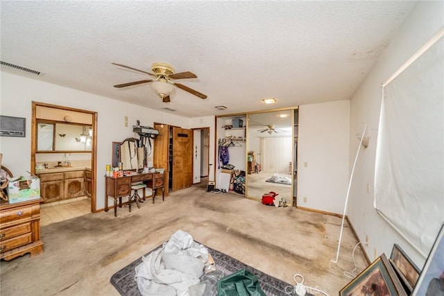 miscellaneous room with carpet floors, visible vents, and a textured ceiling