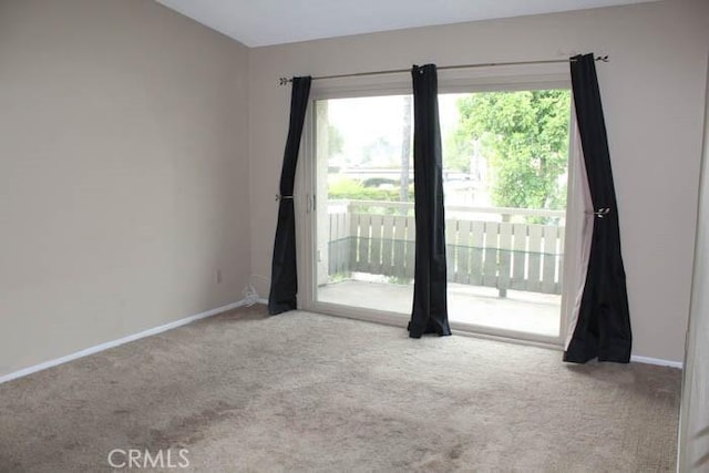 empty room with carpet flooring and baseboards