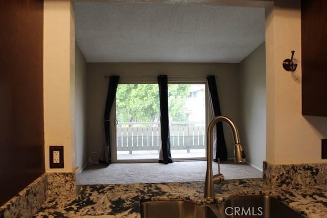 interior space featuring stone counters and a sink