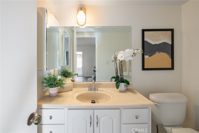 bathroom featuring toilet and vanity