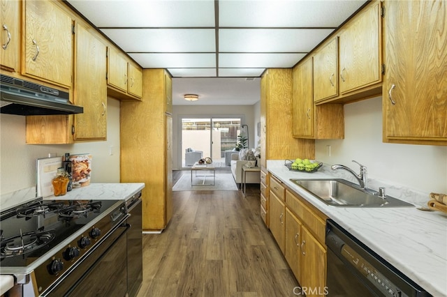 kitchen featuring range with gas stovetop, a sink, light countertops, under cabinet range hood, and dishwasher