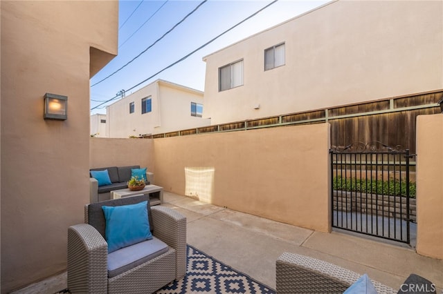 view of patio with outdoor lounge area and fence