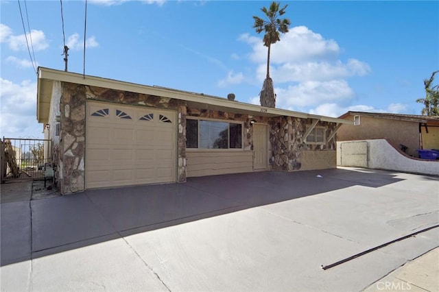 single story home featuring concrete driveway