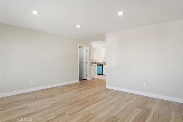 unfurnished room featuring recessed lighting, light wood-style flooring, and baseboards