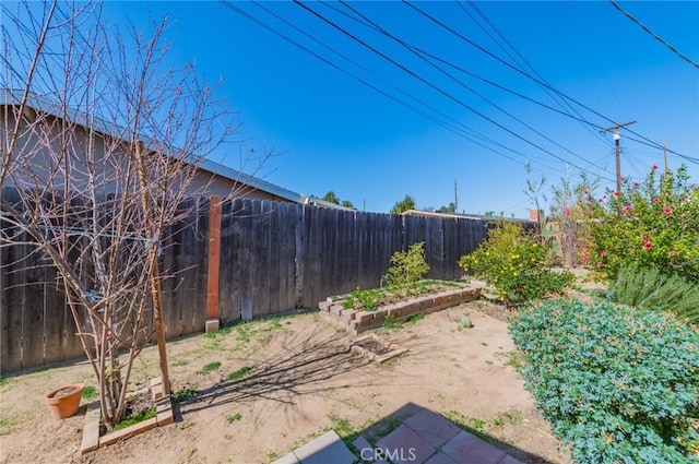 view of yard featuring a garden and a fenced backyard