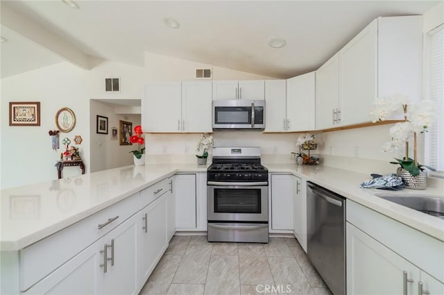 kitchen featuring vaulted ceiling with beams, visible vents, and appliances with stainless steel finishes