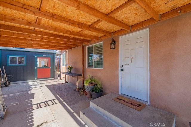 view of exterior entry with stucco siding