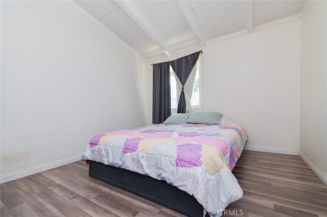 bedroom featuring vaulted ceiling with beams, baseboards, and wood finished floors