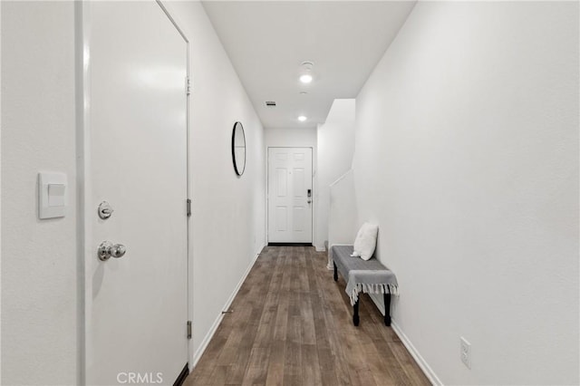 corridor featuring visible vents, baseboards, wood finished floors, and recessed lighting