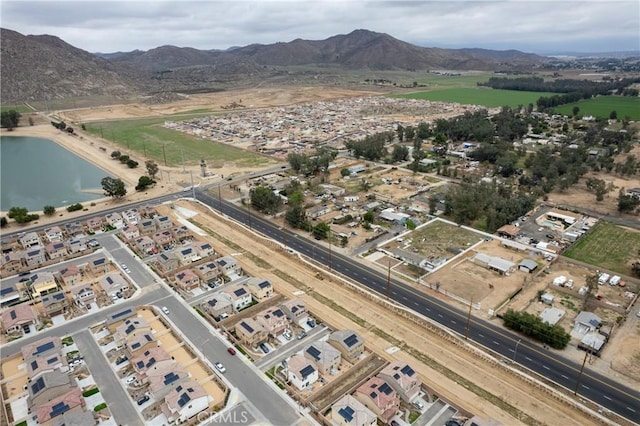 birds eye view of property featuring a water and mountain view