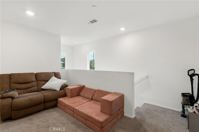 living room featuring light colored carpet, visible vents, baseboards, and recessed lighting