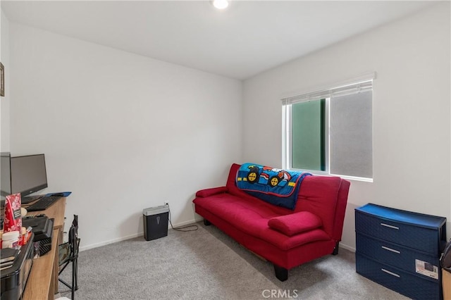 living area featuring carpet floors and baseboards