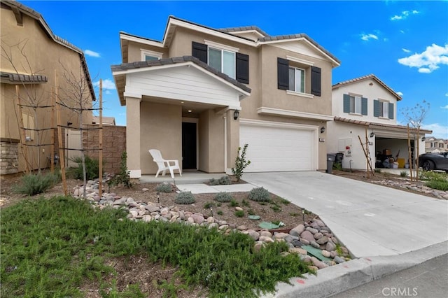 view of front of home with a garage, concrete driveway, a tile roof, and stucco siding