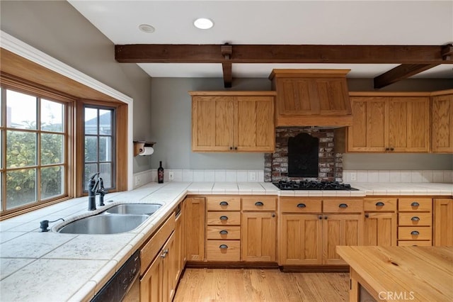 kitchen featuring beam ceiling, black gas cooktop, a sink, light wood-type flooring, and premium range hood