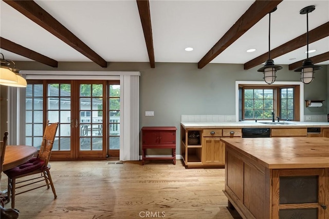 kitchen with tile countertops, a sink, french doors, light wood-type flooring, and dishwasher