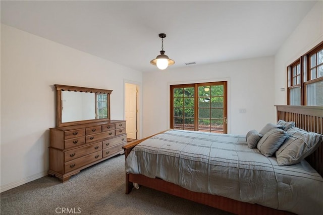 carpeted bedroom with visible vents and baseboards