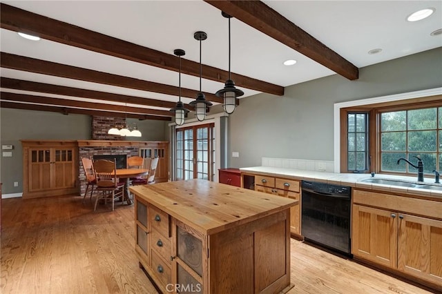 kitchen featuring dishwasher, wood counters, beamed ceiling, light wood-type flooring, and a sink